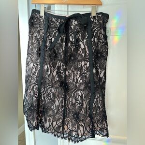 Elegant Black Lace Skirt with ribbon tie and blush underlay.